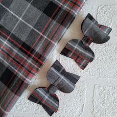 Two tartan bows with red and grey tartan fabric