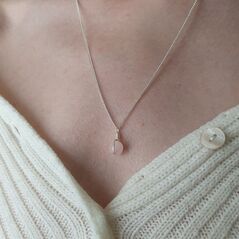 Small light pink rose quartz sphere on dainty silver chain, bound with a simple silver wire wrap