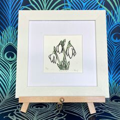 Snowdrop Lino Print Black Line on Watercolour in a white frame on an easel