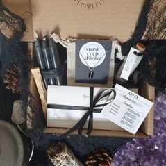 Protection spell box containing black candles, palo santo stick, jar of salt, a handmade black onyx sphere  crystal necklace on dainty silver chain and an original ritual wrote by a  witch
