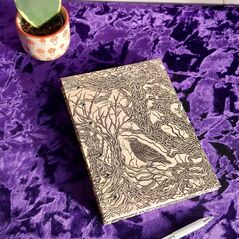 notebook with cover of trees and bird