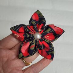 Handmade 3" Flower Hair Clip, Bobble or Brooch using Poppy Fabric shown held in hand.