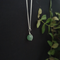 small crystal sphere of green aventurine, bound in a simple silver look wire wrap onto a dainty silver plated chain